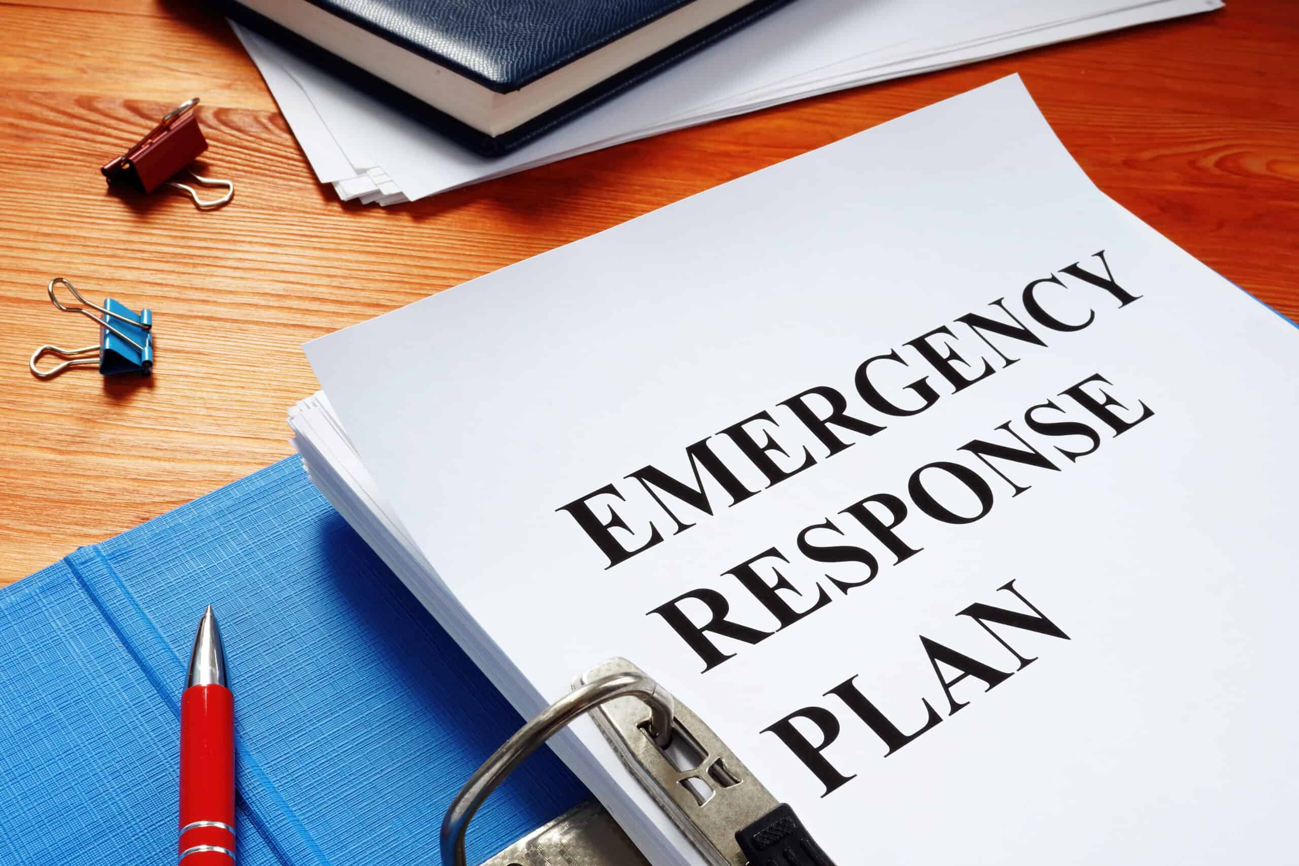 blue open folder with Emergency response plan on it
