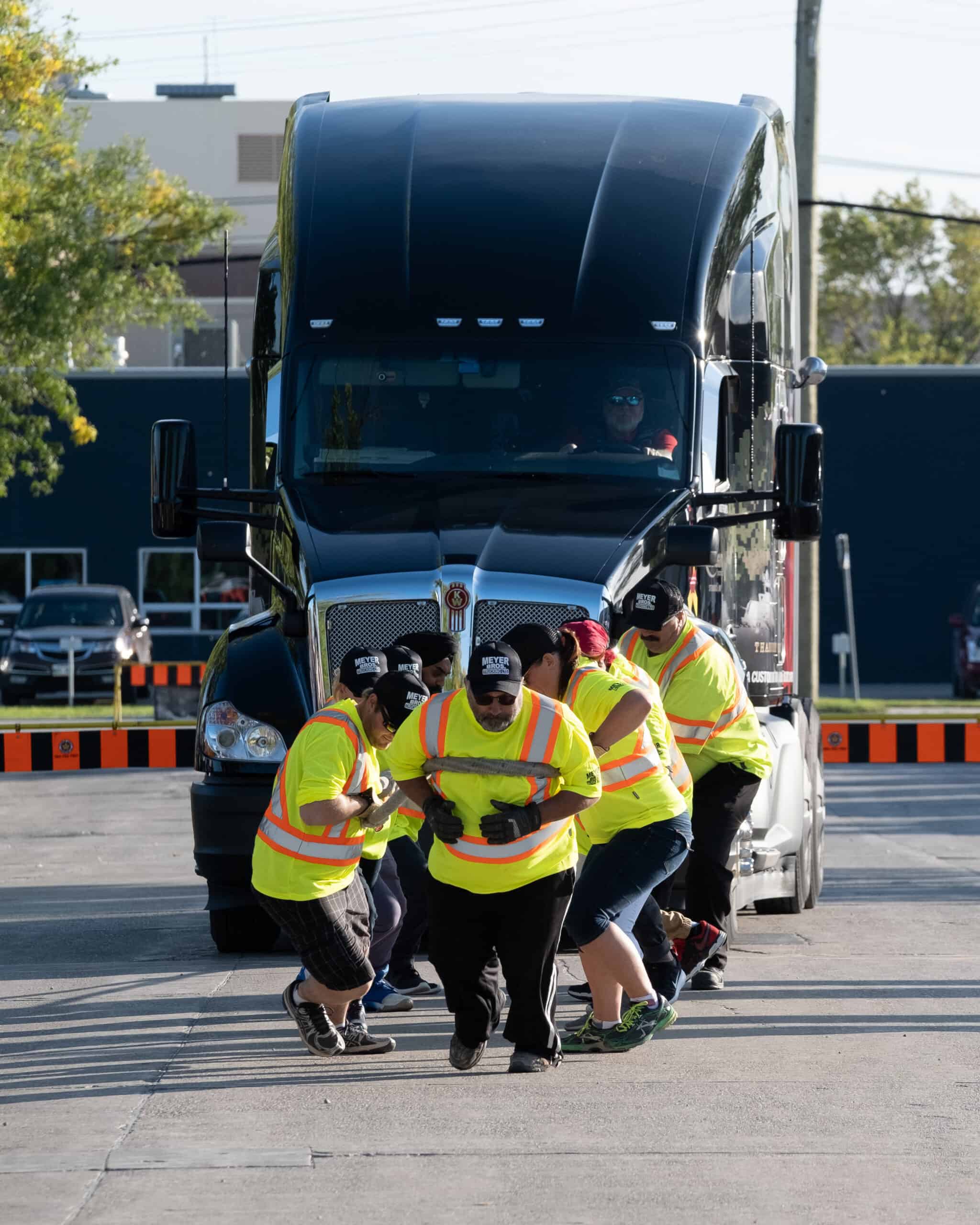 A group of people towing a truck