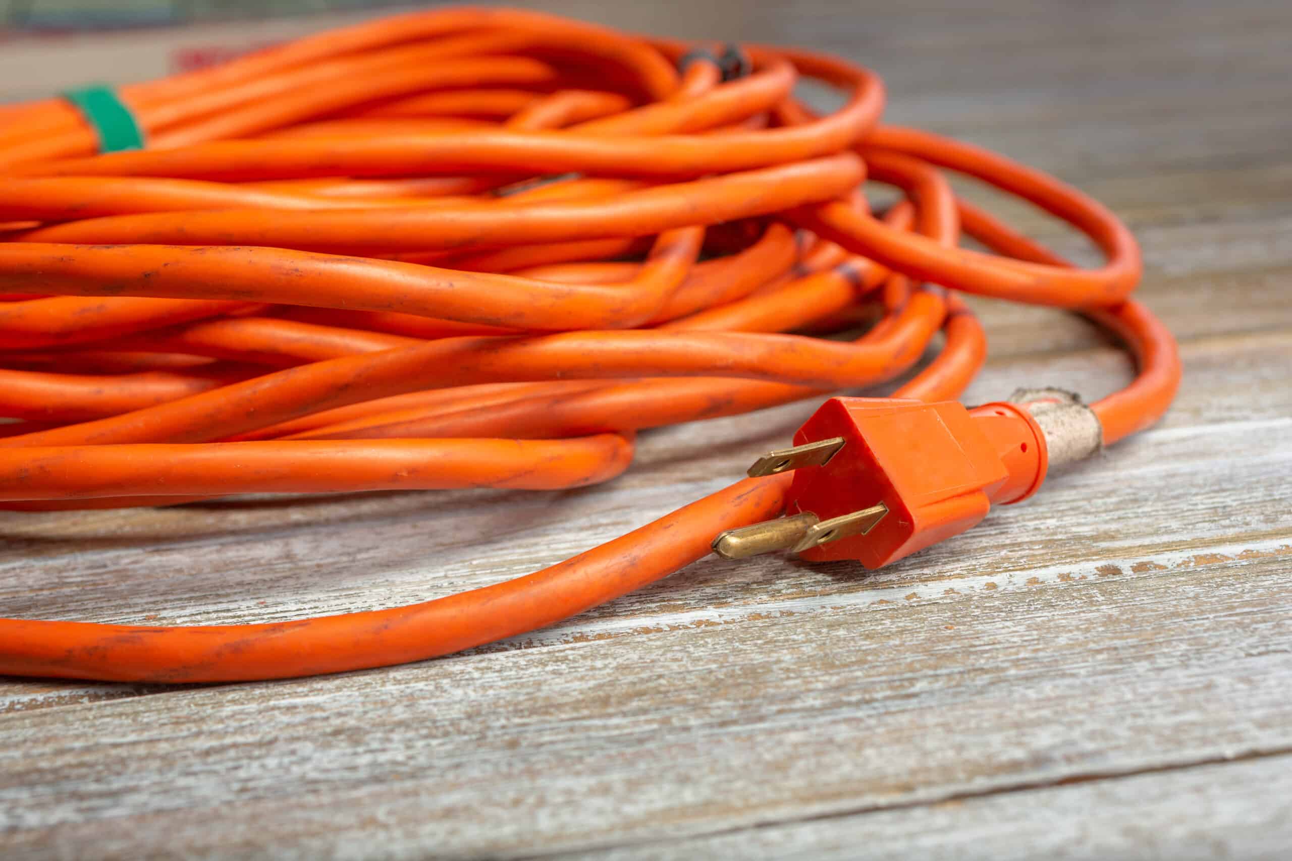 A closeup view of a wrapped orange extension cord featuring the