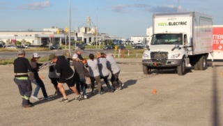 A team pulling a straight truck in the truck pull