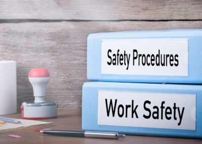 A picture of binders labelled Safety Procedures and Work Safety o a desk.