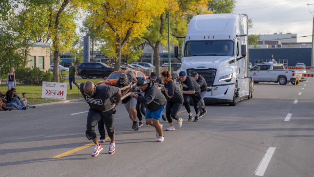 A group of people towing a truck